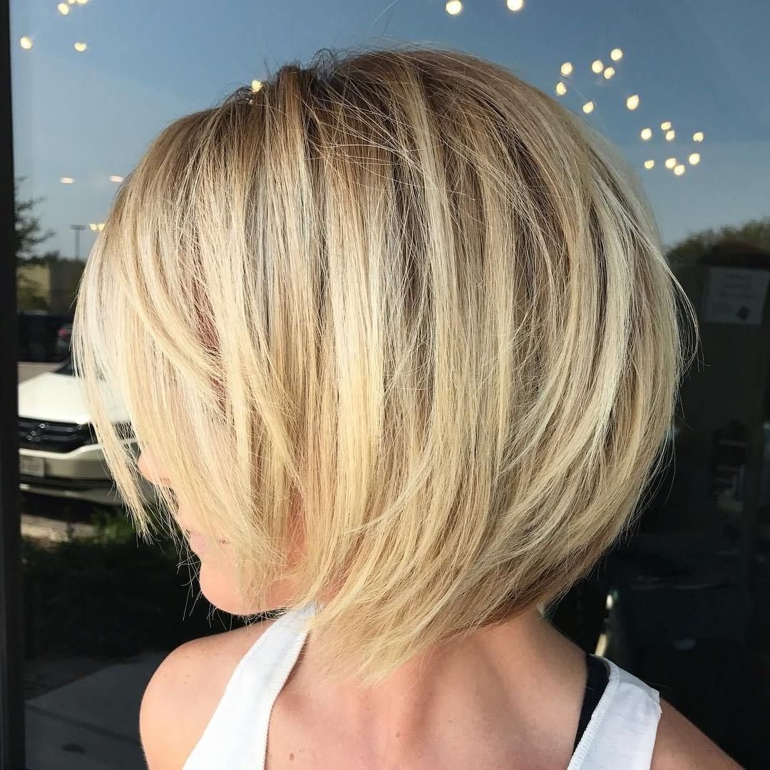 Short Bob With Widely Used Feathered Cut Blonde Hairstyles With Middle Part (View 16 of 20)