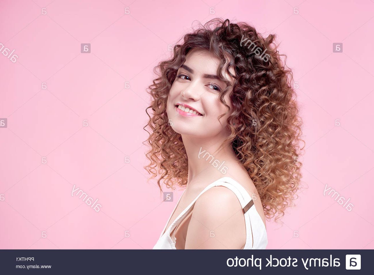Happy Smiling Young Woman With Amazing Hairstyle Curly Shine Hair In With Curly Hairstyles With Shine (View 13 of 20)