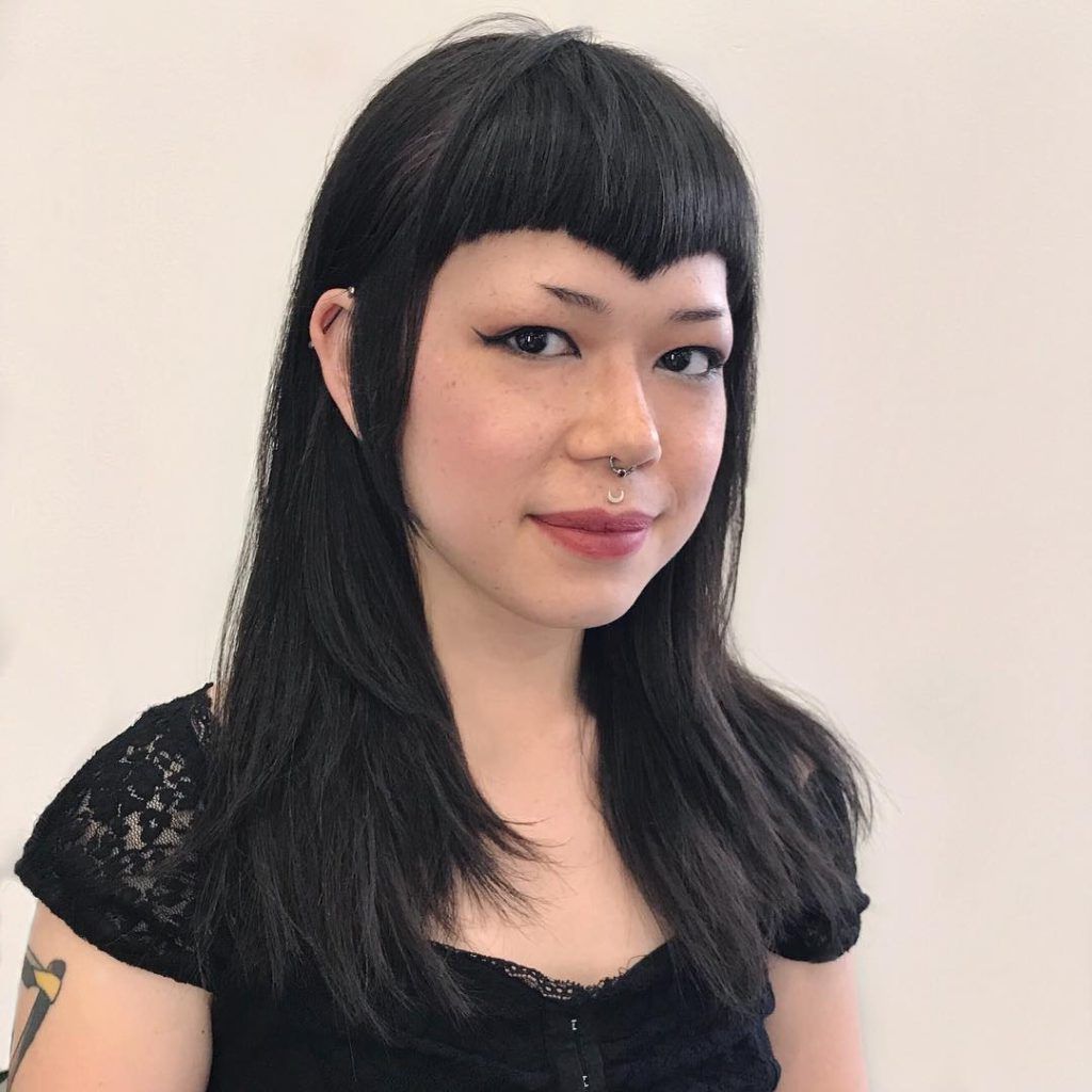 Women's Edgy Face Framing Layered Cut With Curved V Shaped Bangs And In Most Up To Date Black Medium Hairstyles With Bangs And Layers (View 16 of 20)