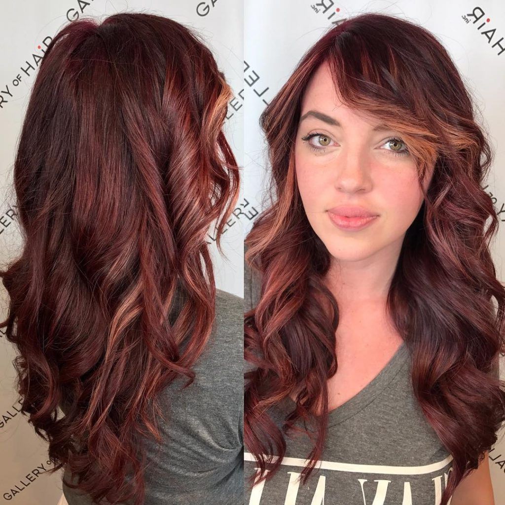 Women's Wavy Layered Cut With Vibrant Burgundy Color And With Most Popular Long Wavy Hairstyles With Side Swept Bangs (View 9 of 20)