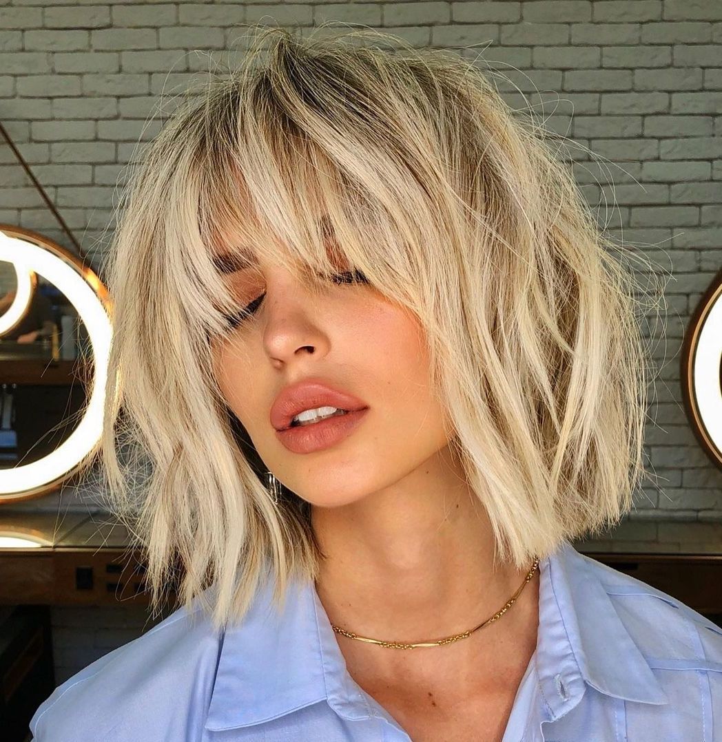 20 Perfect Feathered Bangs You Won't Resist Trying For Famous Elongated Feathered Bangs Hairstyles With Edgy Mob (View 1 of 20)