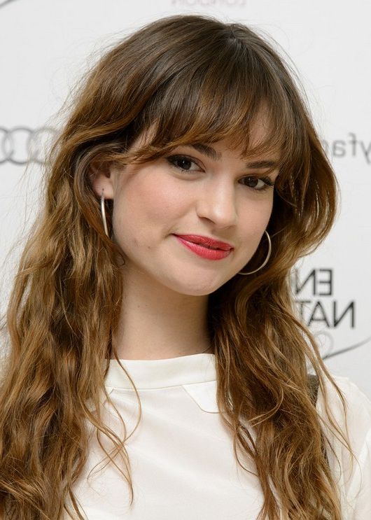 Lily James Messy Long Brunette Wavy Hairstyle With Bangs With Regard To Widely Used Long Wavy Hairstyles With Bangs Style (View 16 of 20)