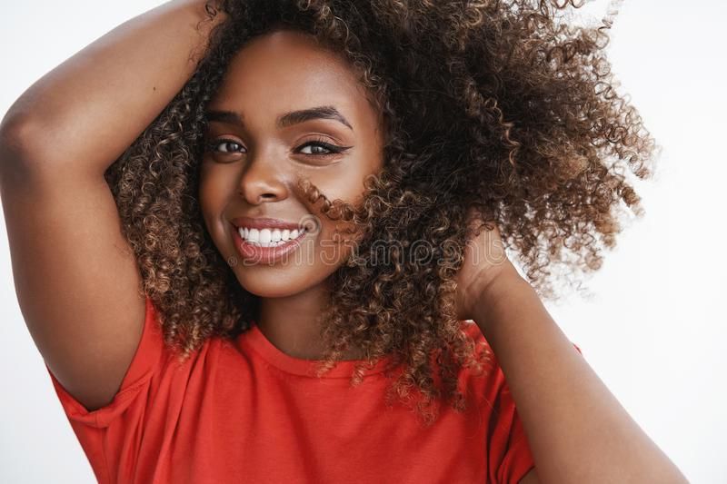 Close Up Shot Of Carefree Relaxed And Tender African American Female Model  In Red T Shirt Playing With Curly Hair Stock Photo – Image Of Lady,  Emotions: 148634532 Within Widely Used Carefree Curls Haircuts (View 19 of 20)