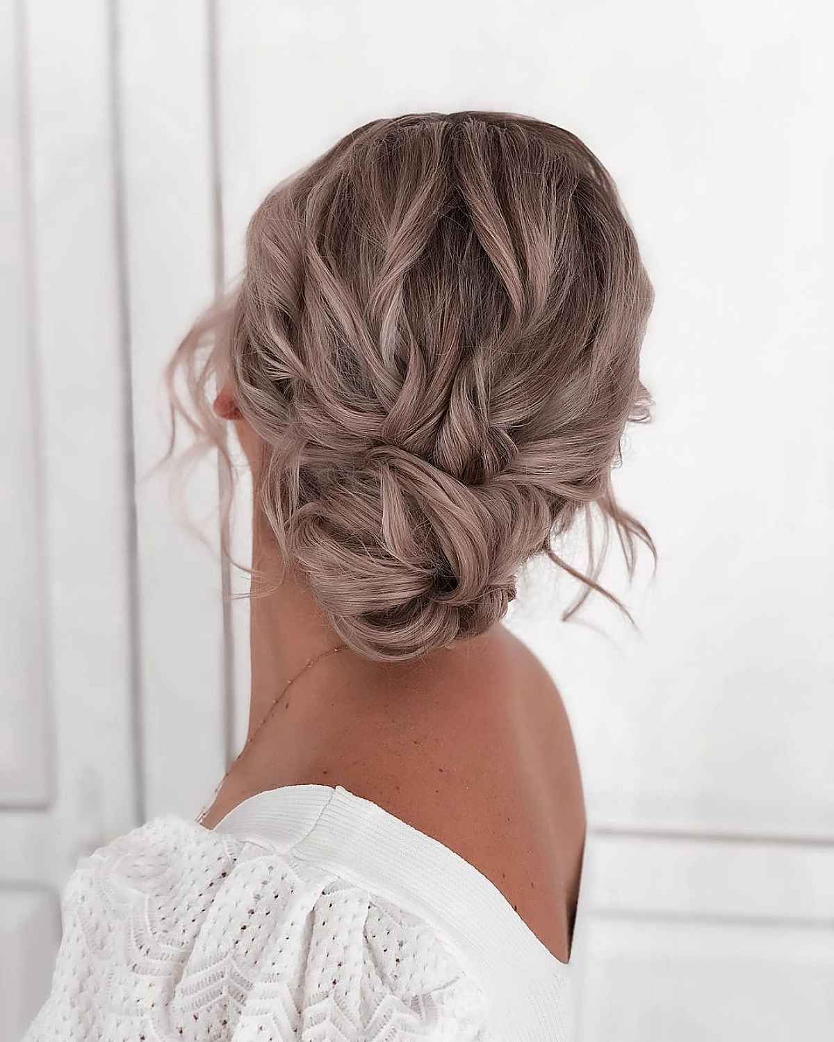 Most Recent Low Formal Bun Updo Inside 20 Romantic Bun Hairstyles For Prom That Are Easy To Do (View 14 of 15)