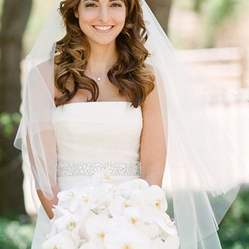 Curly Wedding Hairstyles With An Orchid (Photo 11 of 20)