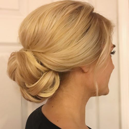 Wavy Low Bun Bridal Hairstyles With Hair Accessory (Photo 14 of 20)