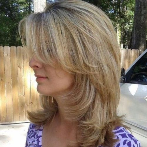 Medium Hairstyles With Perky Feathery Layers (Photo 14 of 20)