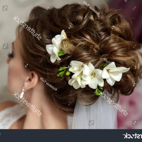 Curly Wedding Updos With Flower Barrette Ties (Photo 12 of 20)