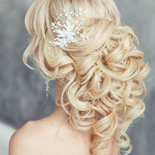 Large Curly Bun Bridal Hairstyles With Beaded Clip (Photo 19 of 20)